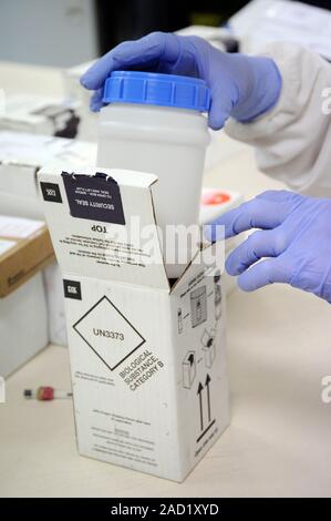 Packaging for infectious material. Close-up of a biomedical researcher handling a specimen of an infectious substance classes as a 'biological substan Stock Photo
