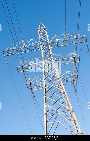 Abstract of large electricity pylon against blue sky Stock Photo