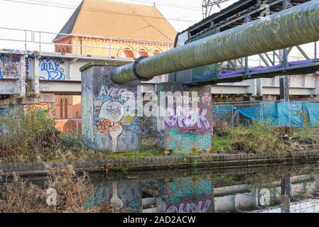 Graffiti painted on a brick wall by a bridge over the Worcester and Birmingham canal in Selly Oak, Birmingham, UK Stock Photo