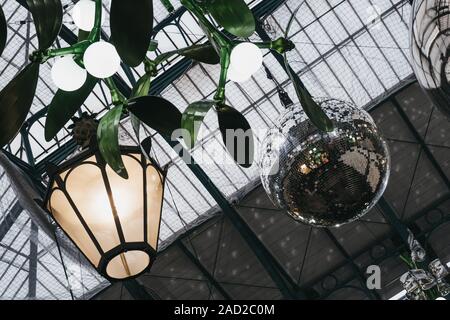 London, UK - November 24, 2019: Christmas decorations and giant baubles in Covent Garden Market, one of the most popular tourist sites in London, sele Stock Photo