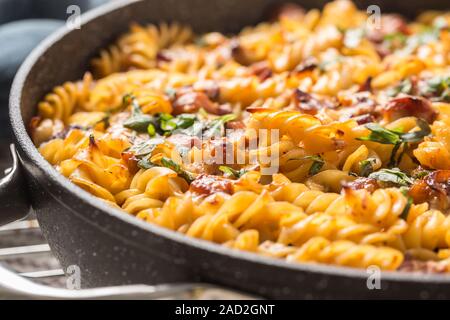 Baked pasta fusilli with smoked pork neck mozzarela cheese and othe ingredients Stock Photo