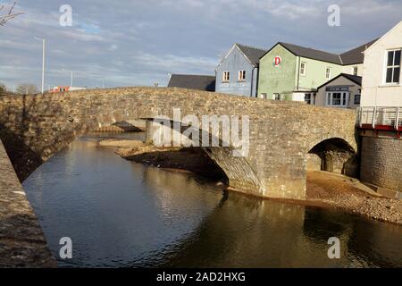 The old town bridge in Bridgend where the carts and horses would enter the town over the river using this very narrow bridge built of local stone. Stock Photo
