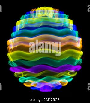 Multicoloured spinning light trails. Stock Photo
