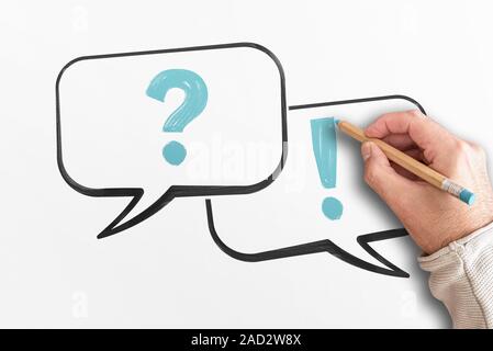 questions and answers concept with top view of hand drawing question mark and exclamation point in speech bubbles Stock Photo