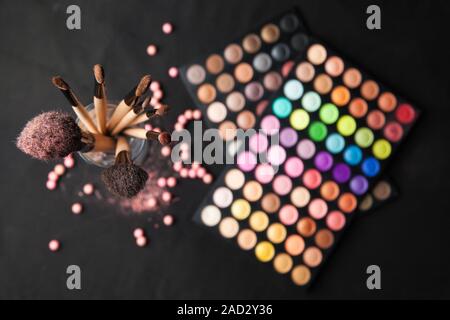 Palette of eyeshadows with brushes isolated on black background Stock Photo