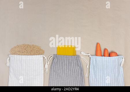 Sustainable canvas bags with groceries, top view. Concept of zero waste and reducing plastic usage: raw food from the market in reusable cotton packag Stock Photo