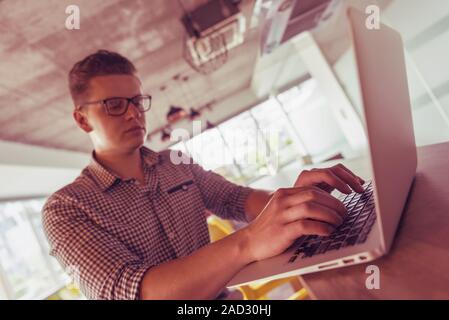 young  man working on laptop Stock Photo