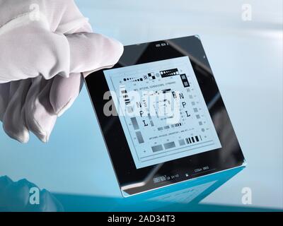 Co-ordinate measuring machine standard. Close-up of a researcher holding an optical dimensional artefact, a standard device used to test and calibrate Stock Photo