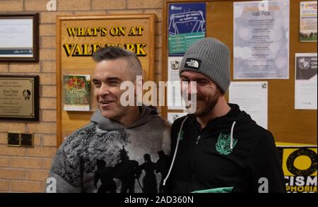 Robbie Williams with Port Vale striker Tom Pope at Port Vale's, Vale Park, near Stoke-on-Trent, after he spoke about his homecoming gig to be held at the football club. Stock Photo