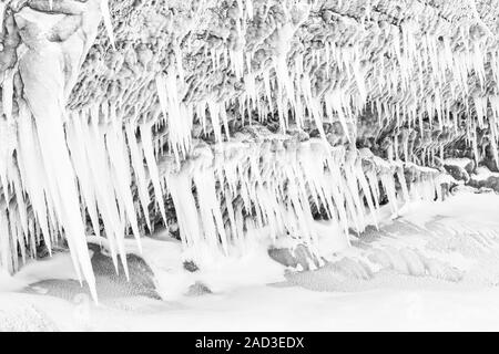 Icicles on a rock, Lake Tornetraesk, Lapland, Sweden Stock Photo