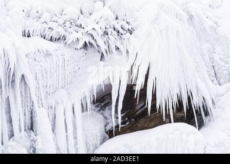 Icicles on a rock, Lake Tornetraesk, Lapland, Sweden Stock Photo