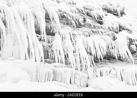 Icicles on a rock, Lake Tornetraesk, Lapland, Sweden Stock Photo