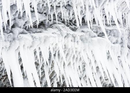 Icicles on a rock, Lake Tornetraesk, Lapland, Sweden Stock Photo