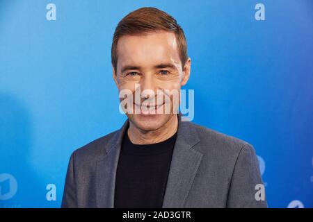 Hamburg, Germany. 03rd Dec, 2019. Kai Pflaume, presenter, stands in front of a logo wall at a photo shoot on the occasion of the ARD annual press conference. Credit: Georg Wendt/dpa/Alamy Live News Stock Photo