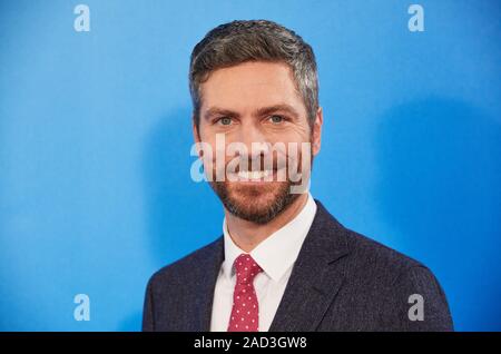 Hamburg, Germany. 03rd Dec, 2019. Ingo Zamperoni, both moderator, stands in front of a logo wall at a photo shoot on the occasion of the ARD annual press conference. Credit: Georg Wendt/dpa/Alamy Live News Stock Photo