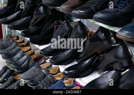 black men's leather shoes on the store counter a large selection. Selective focus Stock Photo