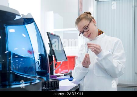Haematology laboratory. Haematologist preparing blood samples for minicap flex piercing to test for haemoglobinopathy. Haemoglobinopathies are genetic Stock Photo