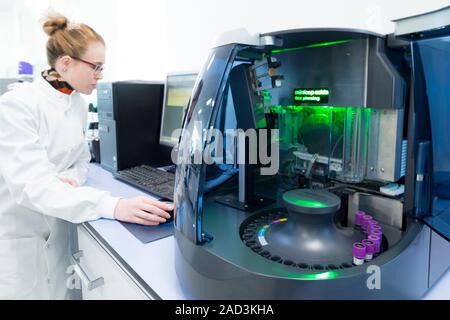Haematology laboratory. Haematologist using minicap flex piercing to analyse blood samples for haemoglobinopathy. Haemoglobinopathies are genetic defe Stock Photo