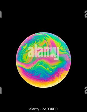 Soap bubble colours. The movement in the thin film is due to the interaction between gravity and buoyancy in the liquid. The colours are produced by t Stock Photo