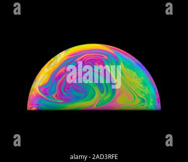 Soap bubble colours. The movement in the thin film is due to the interaction between gravity and buoyancy in the liquid. The colours are produced by t Stock Photo