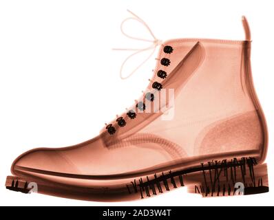 Boot. Coloured X-ray of a boot, showing the lace eyelets (dark, centre) and nails (dark, lower left and right) used to attach the sole. Stock Photo