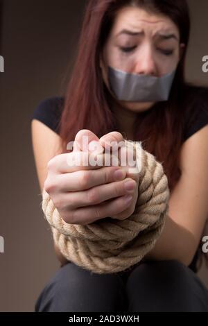 Girl victim with tied hands Stock Photo - Alamy