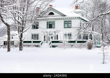 Large older traditional home after a snowfall. Stock Photo