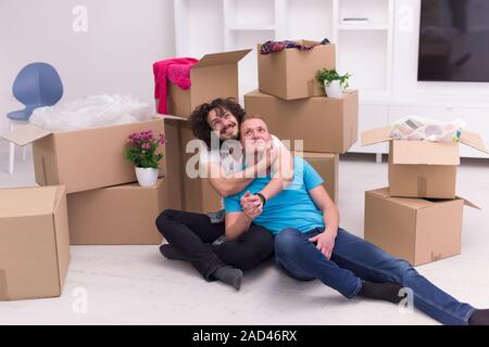 young  gay couple moving  in new house Stock Photo