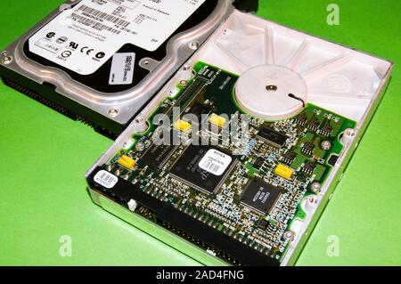 Two hard disk drives from a desktop personal computer showing upper and lower surfaces, the latter with exposed printed circuit board with semiconduct Stock Photo