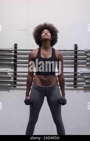 black woman doing bicep curls Stock Photo