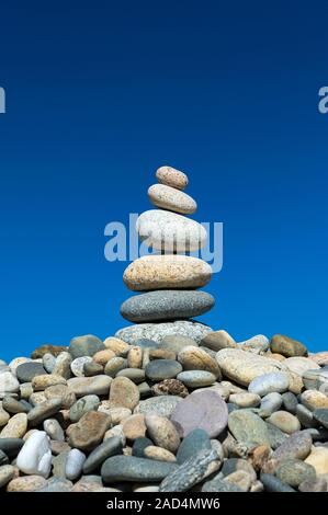 Cairn. Cairn amongst other rocks on a beach. Cairns are piles of stones traditionally used as marking points. Photographed at Stonewall Beach, Chilmar Stock Photo