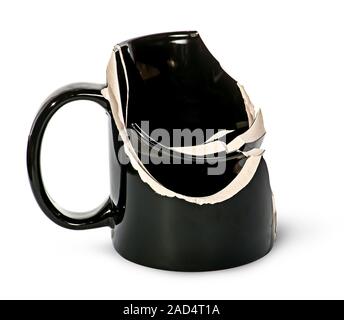 Broken black ceramic cup fragments are inside Stock Photo