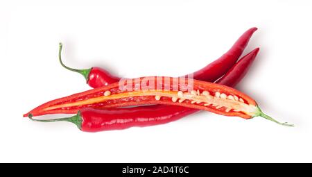 Two whole and one half red chili peppers Stock Photo