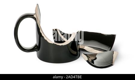 Broken black porcelain cup with fragments Stock Photo