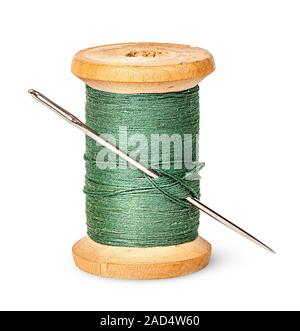 Isolated wooden spool of green thread with a needle 10218377 Stock