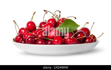 Pile of sweet cherries with leaf on white plate Stock Photo