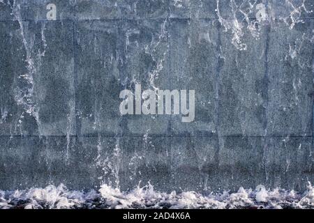 running water on stone background texture. Abstraction waterfall, fountain running water Stock Photo
