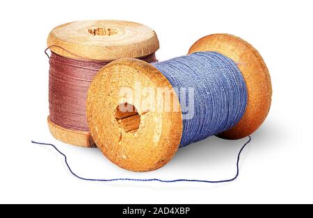 Two different colored thread on wooden spools Stock Photo