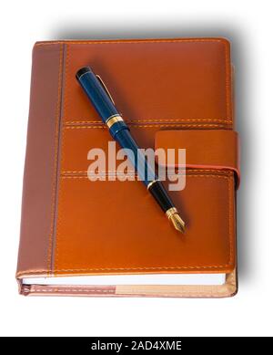 Fountain pen on top of the closed notebook Stock Photo