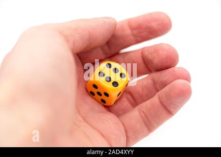 Hand and yellow Casino Dices, Craps isolated on white Background Stock Photo
