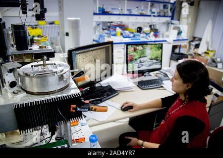 A researcher engaged in magnetic sequencing of DNA (deoxyribonucleic acid). This technology involves the conversion of sections of DNA molecules into Stock Photo