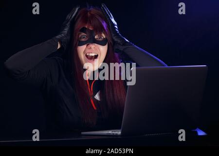 Hacker steals information from computer Stock Photo
