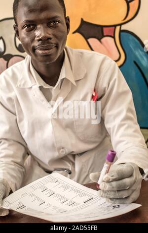 Hospital doctor handling a blood sample. Photographed in St Mary's Hospital, Lacor, Gulu, Uganda. Stock Photo