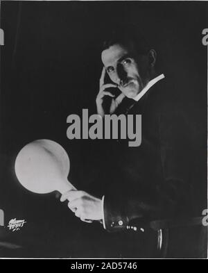 Nikola Tesla (1856-1943), Serb-US physicist and electrical engineer, holding a 'wireless light bulb'. Tesla was educated at Graz and Prague, but in 18 Stock Photo