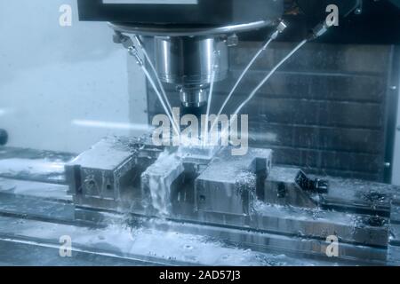 CNC milling machine cutting the tire mold part with the solid ball end-mill tool and coolant fluid Stock Photo