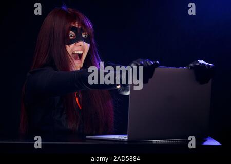 Girl steals information from computer Stock Photo