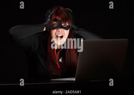 Woman steals information from computer Stock Photo