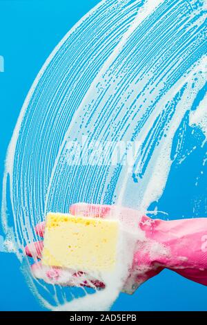 Man cleaning glass with sponge Stock Photo