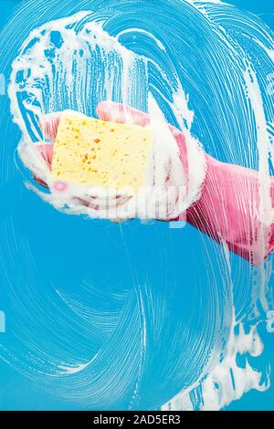 Man with glove cleaning window Stock Photo