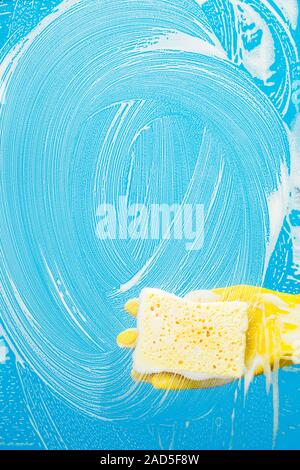 Man with sponge cleaning window Stock Photo